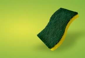 a new scotch-brite heavy duty scrub sponge floating over a green background
