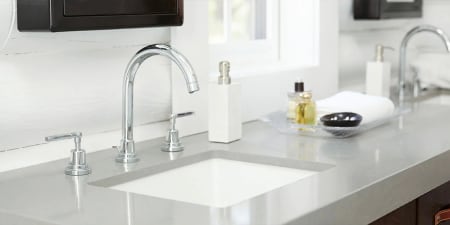 A very clean and polished bathroom countertop and sink.