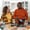 Three friends gather around a kitchen island, chatting and enjoying drinks, creating a lively and warm atmosphere.
