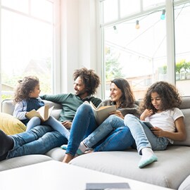 a family sitting on the couch