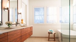Washroom with double sink and large glass shower 

