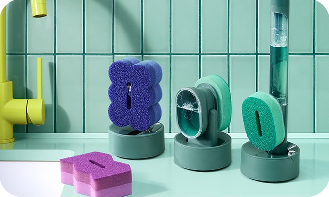 The Brite by Scotch-Brite cleaning collection on a counter with teal colored tiles in the background.
